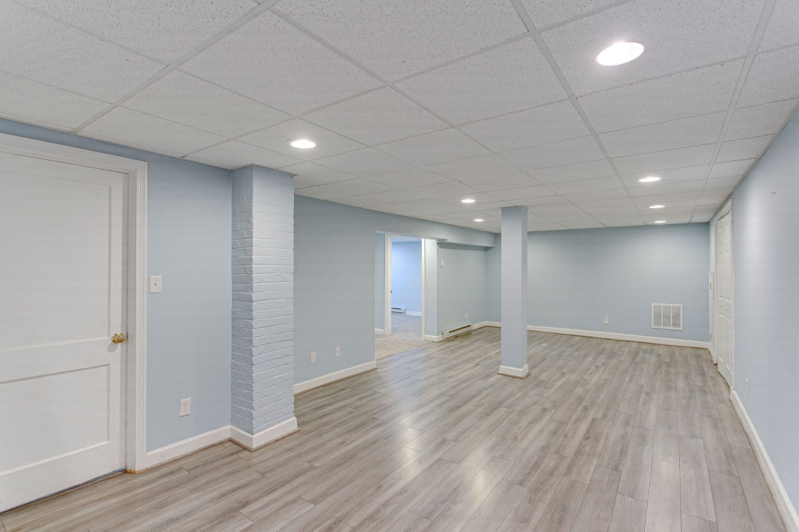 Basement remodeling in Brooklyn, NY showcasing various flooring options including laminate flooring