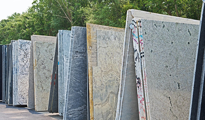 Various Granite Slabs In A Warehouse For Countertops, Featuring Different Colors For Kitchen Remodel Projects